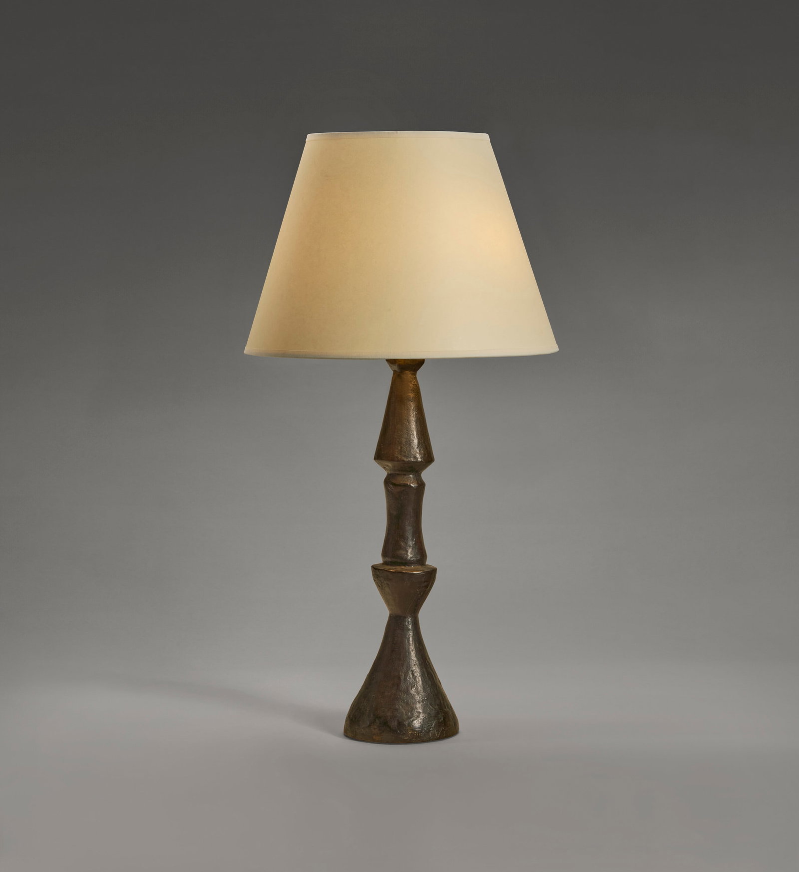 ALBERTO GIACOMETTI (1901-1966) 'Flambeau' Table Lamp, Grand Modèle, designed circa 1934: Details ALBERTO GIACOMETTI (1901-1966) 'Flambeau' Table Lamp, Grand Modèle, designed circa 1934 patinated bronze, paper shade 26 ½ in. (67.3 cm) high, 14 in. (35.5 cm) diameter of shade impr