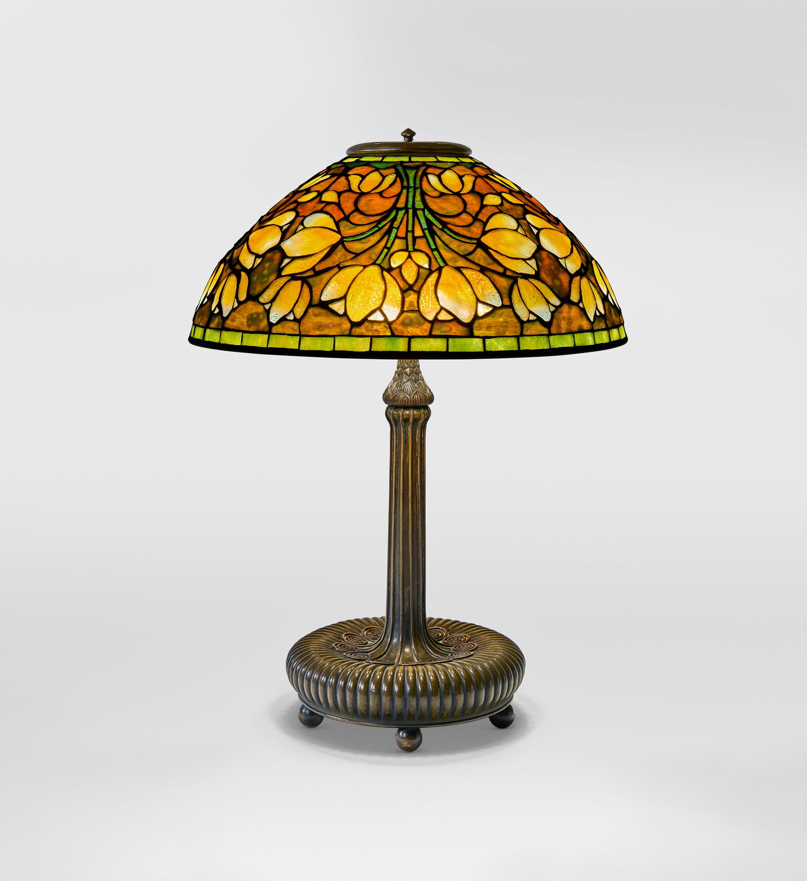 TIFFANY STUDIOS 'Crocus' Table Lamp, circa 1910: Details TIFFANY STUDIOS 'Crocus' Table Lamp, circa 1910 leaded glass, patinated bronze 22 in. (55.9 cm) high, 16 ¼ in. (41.2 cm) diameter of shade Provenance Macklowe Gallery, New York Private Co