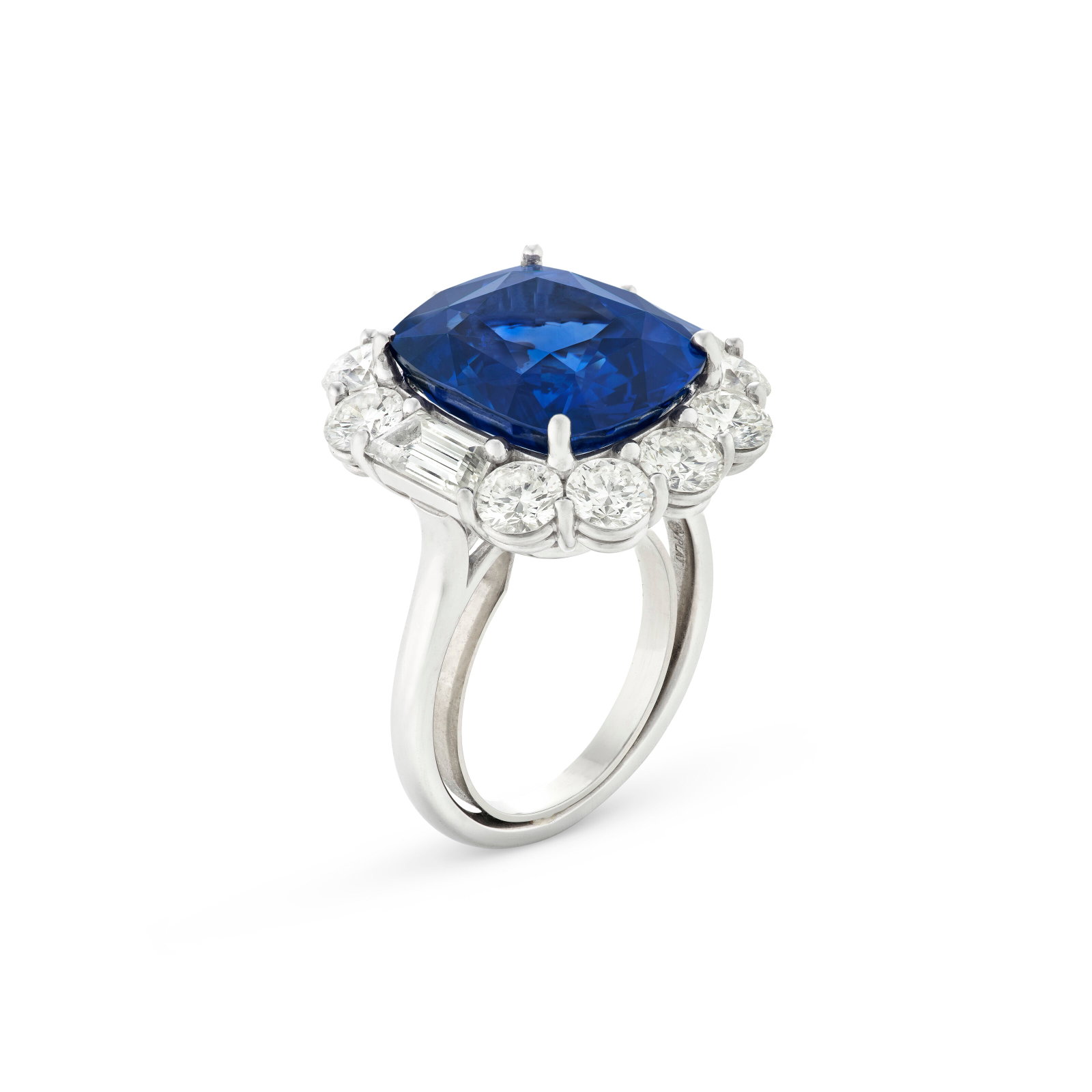 OSCAR HEYMAN & BROTHERS SAPPHIRE AND DIAMOND RING: OSCAR HEYMAN & BROTHERS SAPPHIRE AND DIAMOND RING Details Cushion modified mixed-cut sapphire of 12.12 carats, round and trapezoid-shaped diamonds, platinum, maker's mark, numbered, black Oscar