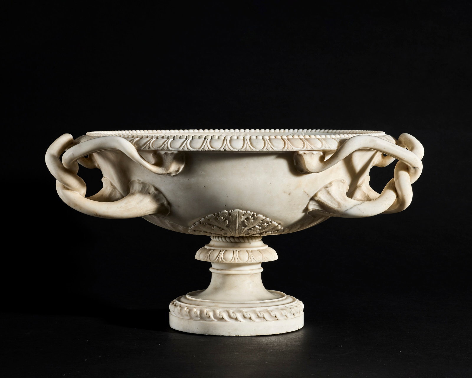 AN ITALIAN WHITE MARBLE TAZZA ATTRIBUTED TO LORENZO CARDELLI, ROME, LAST QUARTER 18TH CENTURY: Details AN ITALIAN WHITE MARBLE TAZZA ATTRIBUTED TO LORENZO CARDELLI, ROME, LAST QUARTER 18TH CENTURY The dished body with egg-and-dart moulding and beaded edge, flanked by foliate intertwined handles