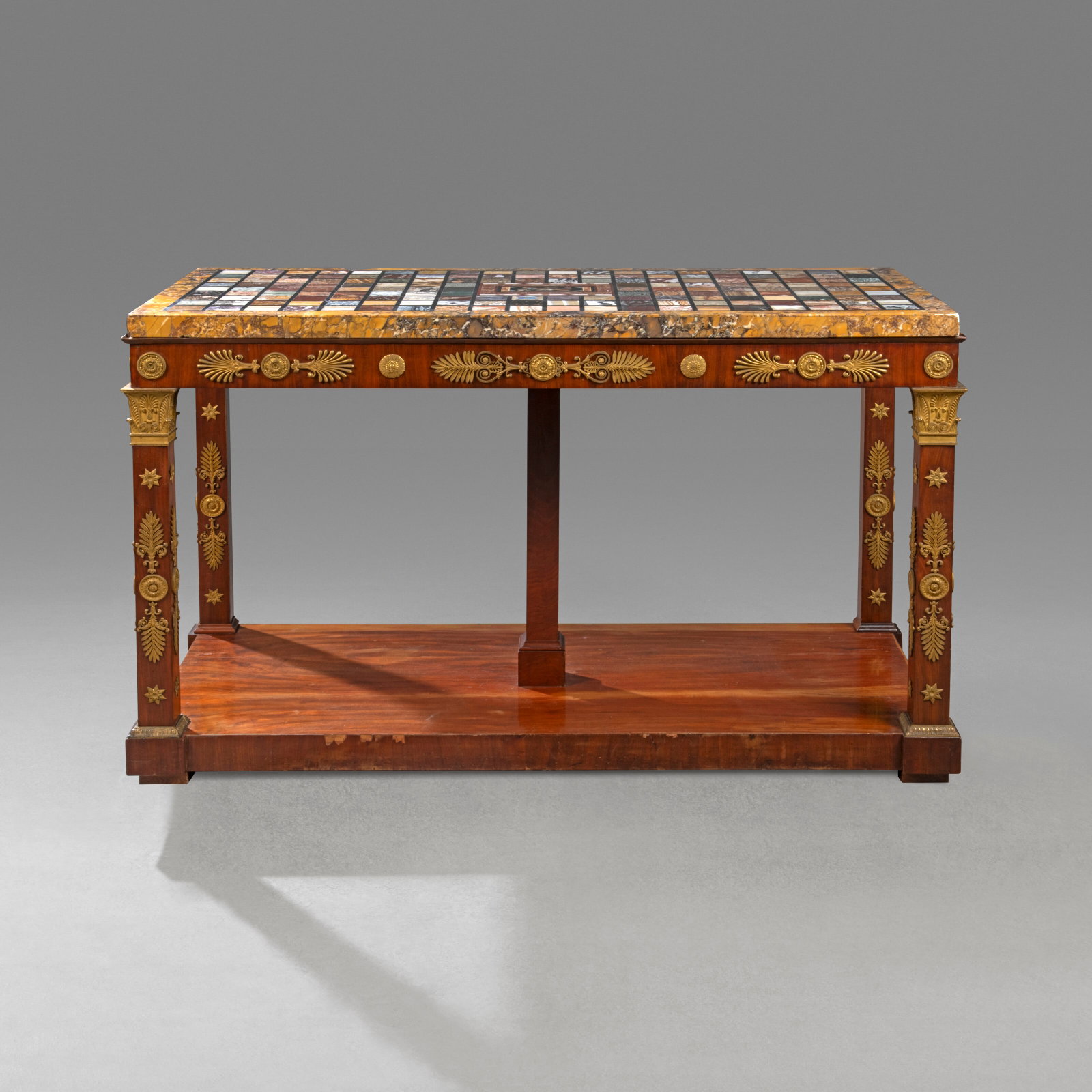 AN EMPIRE ORMOLU-MOUNTED MAHOGANY, PIETRA DURA AND SPECIMEN MARBLE CONSOLE TABLE THE TOP ITALIAN,: Details AN EMPIRE ORMOLU-MOUNTED MAHOGANY, PIETRA DURA AND SPECIMEN MARBLE CONSOLE TABLE THE TOP ITALIAN, CIRCA 1800, THE BASE PROBABLY GERMAN, CIRCA 1810 The rectangular top with brocatello di Siena 