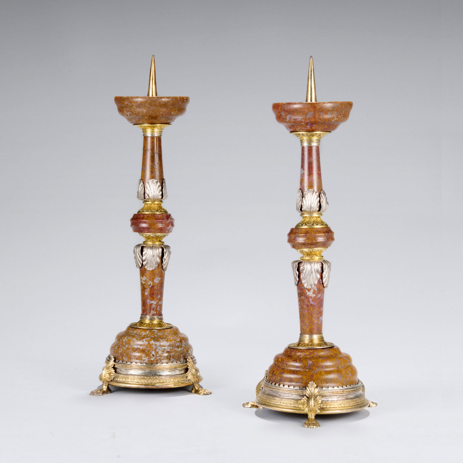 A PAIR OF CENTRAL EUROPEAN PARCEL-GILT SILVER JASPER CANDLESTICKS LATE 16TH/EARLY 17TH CENTURY,: Details A PAIR OF CENTRAL EUROPEAN PARCEL-GILT SILVER JASPER CANDLESTICKS LATE 16TH/EARLY 17TH CENTURY, PROBABLY BOHEMIAN The dished top with stepped moulding, with a leaftip collar, the turned and mo