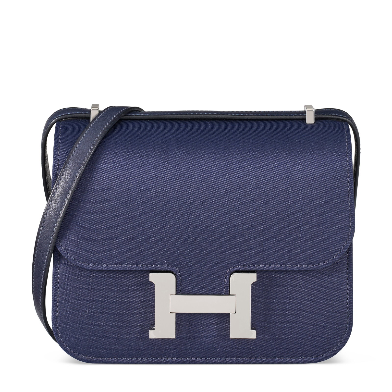 A LIMITED EDITION BLEU NUIT SILK MINI CONSTANCE MIRROR WITH PALLADIUM HARDWARE HERMÈS, 2024: Details GRADE: 1.5 18 w x 14 h x 5 d cm Includes mirror, dust bag, felt protector, care card, ribbon, and limited edition blue box.