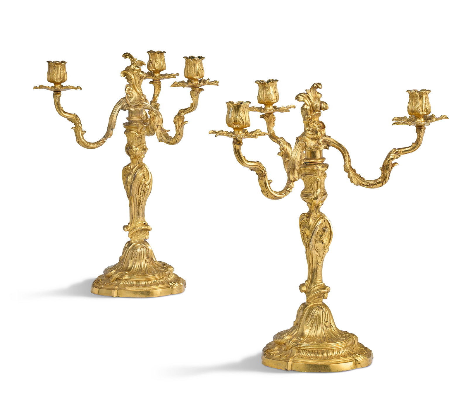 A PAIR OF LOUIS XV ORMOLU THREE-LIGHT CANDELABRA IN THE MANNER OF JUSTE-AURELE MEISSONNIER, CIRCA: Details Each cast all-over with scrolling rocaille, acanthus, cartouches and fluting, the candle-arms removable allowing conversion into candlesticks 151⁄4 in. (39 cm.) high Provenance Acquired 