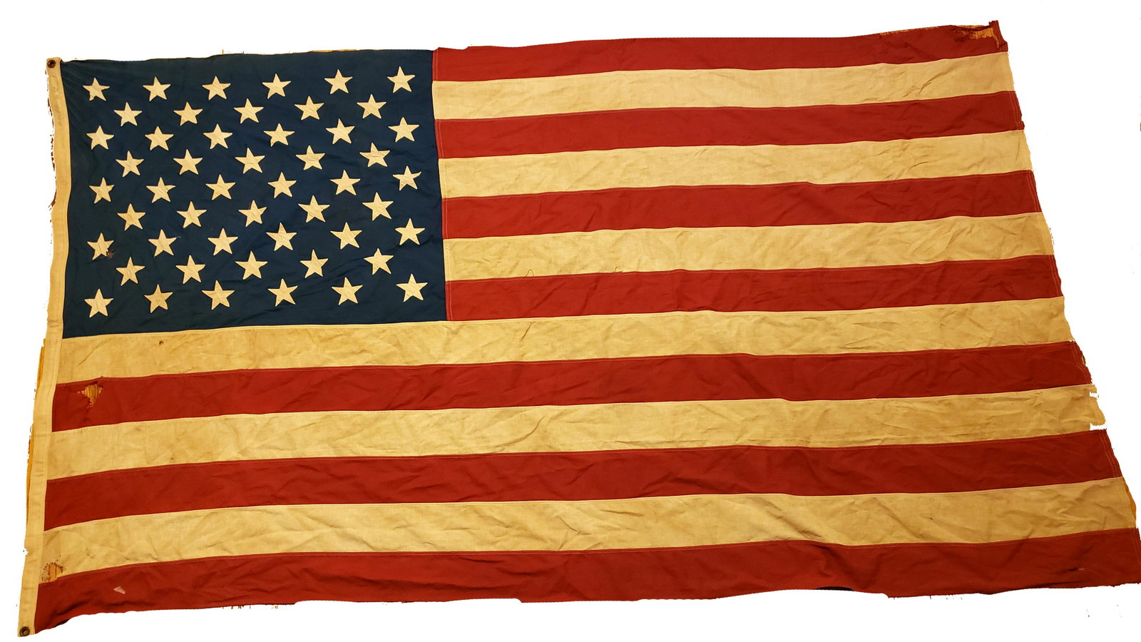 Vintage American Flag 50 Stars 8x5 ft!: Vintage American flag 50 stars measures 6x5 feet,the flag has holes some small and some bigger,it has a stamp of maker but color got faded so can't figure out the maker and material,please check the p