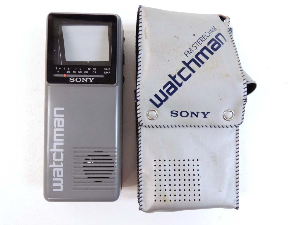 Lot of Vintage Collectibles: Sony Watchman in a CaseBox of old photosWWII Christmas CardsPinking Shears in a boxRay-O-Vac Lantern BulbEmpty Vintage Boxes: AM/FM Radio, Raytheon Vacuum TubesCanister of ACME Bordeaux Mix