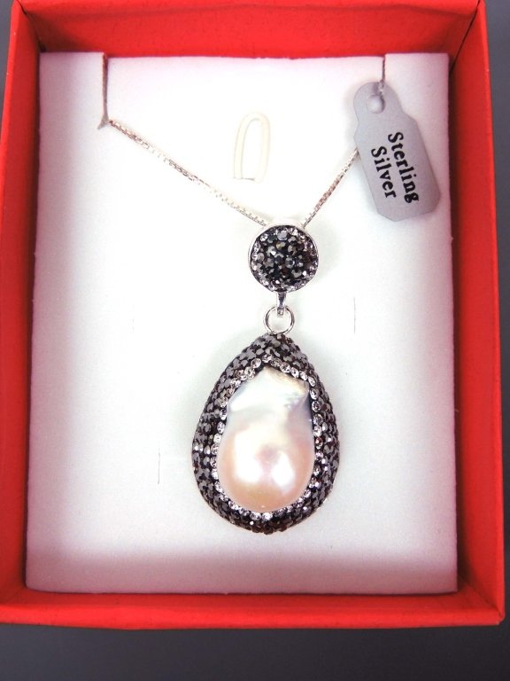 Natural Baroque Pearl Necklace: Natural baroque pearl surrounded with black & clear crystals on a sterling silver mounting with a 20" chain. NOTE: INCORRECT PHOTO CORRECTED 5:30am, 1/30.