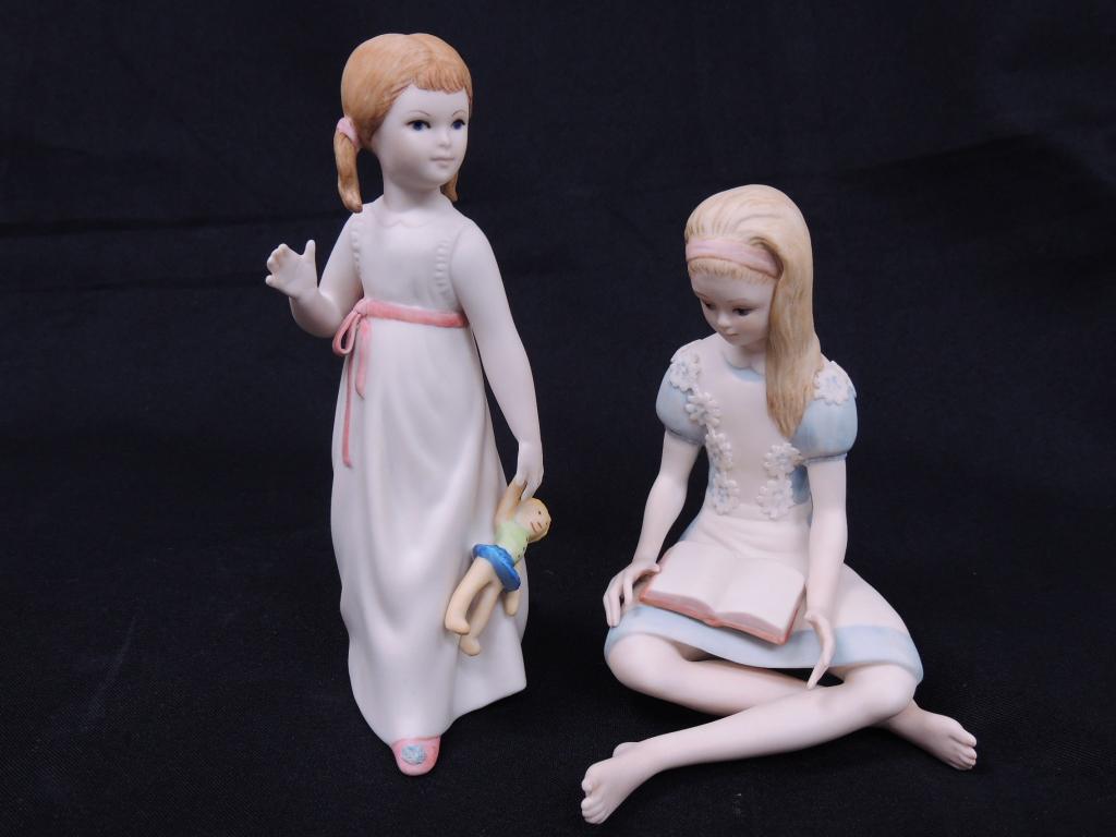 Cybis Porcelain Girls - with Book and Doll: Girl Reading Book - 5" tall. Marked Sxxx or 5xxx. Girl Holding Doll - 6.5" tall.