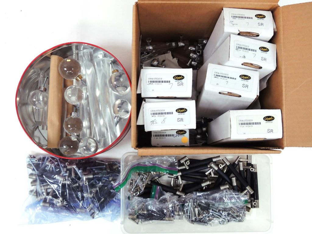 Drawer and Cabinet handles and pulls: 60 lucite and chrome drawer pulls, boxes of screws. Matching knobs and bars (no ends for mounting). Bin of rubberized black and brushed steel pulls. Local pick up only. No shipping available for this 
