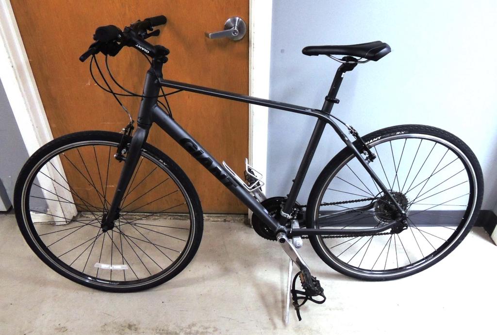 Giant Escape Bicycle: 2015ish. Escape 3, On-Road Sport. Shimano components, Aluminum frame. Original Giant wheels (need truing) and Giant tires (700 x 32c), excellent condition. Giant Connect Saddle. 57cm top tube.53.5cm S