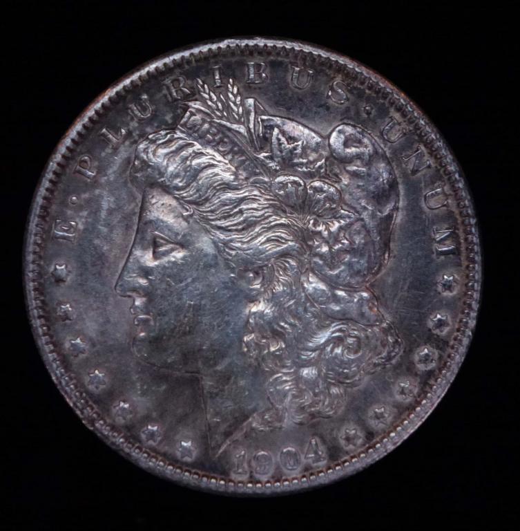 1904 Morgan Silver Dollar (Toned): 1904 Morgan Silver dollar (Philadelphia mint). 90% silver. Some toning.
