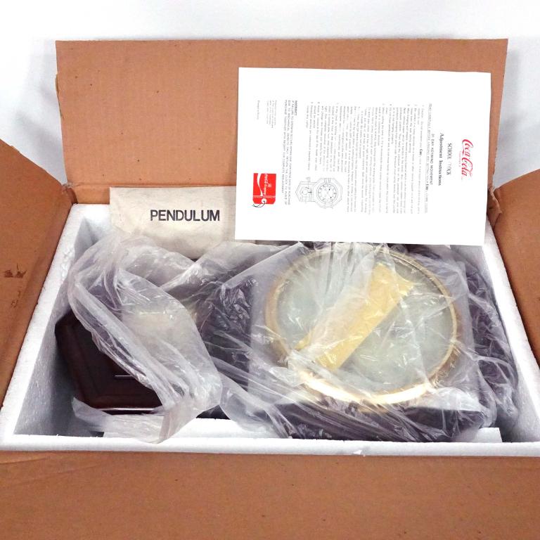 Coca-Cola School Clock: Coca-Cola school clock in original shipping box with pendulum and key. 19 3/4" x 12". 11 lbs. Not tested. Never unpacked. 1990.