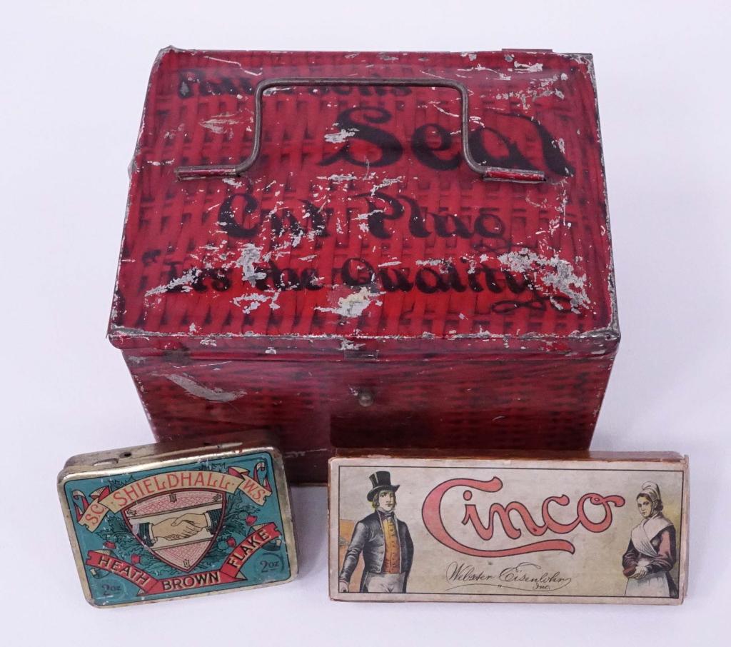 Two Tins & Box: Box- Webster Eisenlohr Cinco Cigars. Some damage. 1926 tax stamp. 5 1/8" x 2 1/8".*** Tins- Shieldhall Heath Brown Flake 2 oz. 3 1/4" x 2 1/2". R. A. Patterson Seal with partial John Q Adams tax stamp