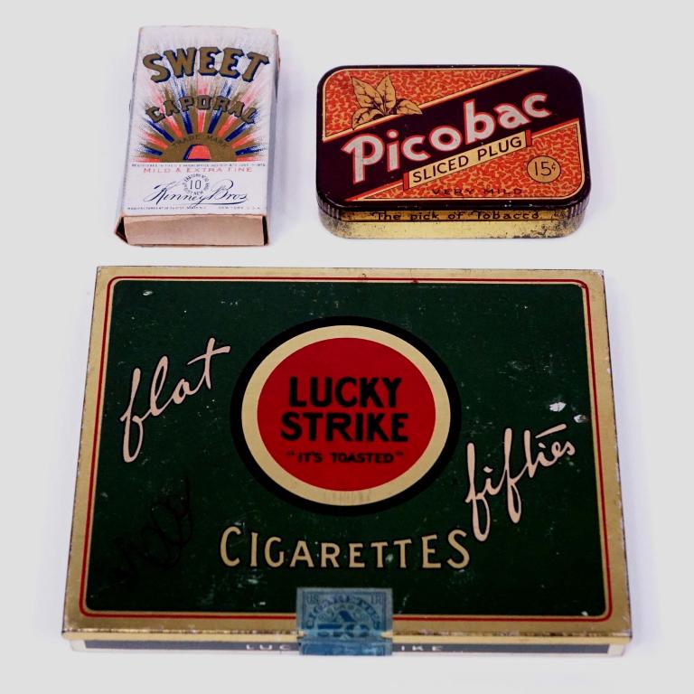 Tins and Box: Lucky Strike Flat Fifties Tin. DeWitt Clinton tax stamp. 5 3/4" x 4 1/2". *** Picobac sliced plug. ***Sweet Caporal box with 1893 tax stamp.