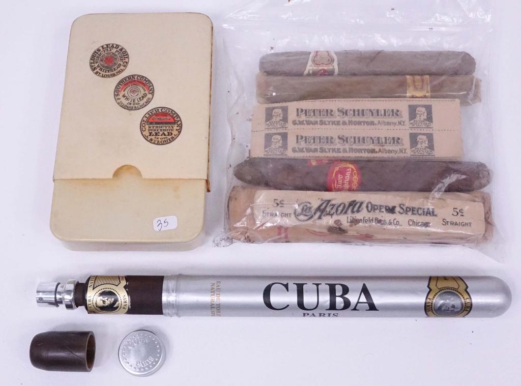 Cigar Lot: National Lead Company cigar case. Includes four Ashton cigars.*** La Azora Opera special scent.*** Peter Schuyler Cigars.*** Cuba Paris Men's Cologne.