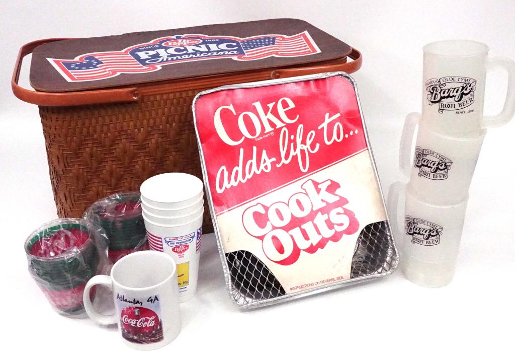 Coca-Cola Branded Picnic Supplies: Dr. Pepper picnic basket and vintage Coca-Cola one match mini grill; 3 Bargs plastic tall mugs, 2 sleeves, disposable cups, Coke Atlanta coffee mug, flags of the USA plastic cups. Bottom is stained, s