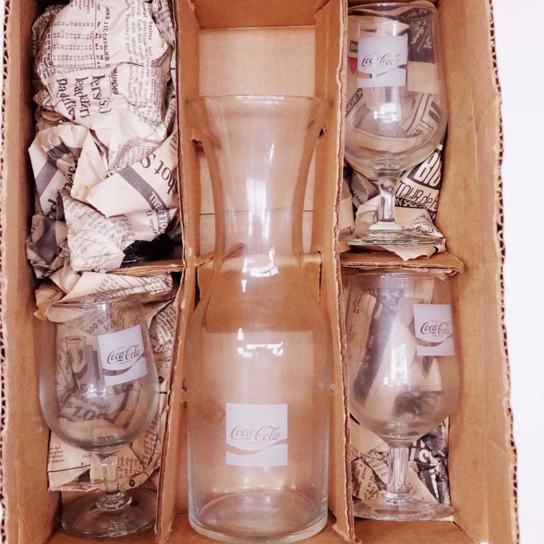 Coca-Cola Wine Carafe & Glasses Set: Coca-Cola wine carafe and glasses set. Pre-1987. 1 carafe and 4 glasses in original box.