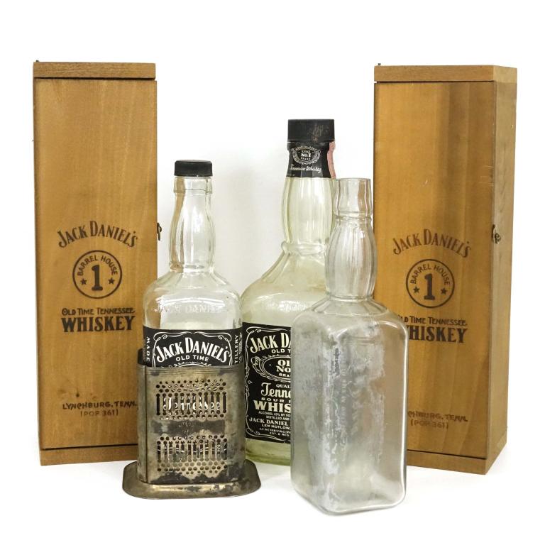 Jack Daniels Bottle Lot (4): 1.75 L bottle. 750 ml bottle in silverplate holder. Older bottle (no label, no volume in glass). 1994 Barrel House bottle in wood case and extra wood case. LOCAL PICKUP OR THIRD PARTY SHIPPING ONLY.
