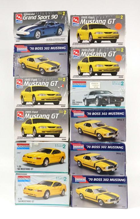 12 Vintage Model Cars: 1 Monogram 1992 Firebird Formula, 1991. 1:24 scale. Made in the U.S.A; 1 AMT ERTL Guldstrand Grand Sport 90, 1994. 1/25 scale. Made in the U.S.A; 2 AMT ERTL 1995 Ford Mustang GT, 1994. 1/25 scale. Mad