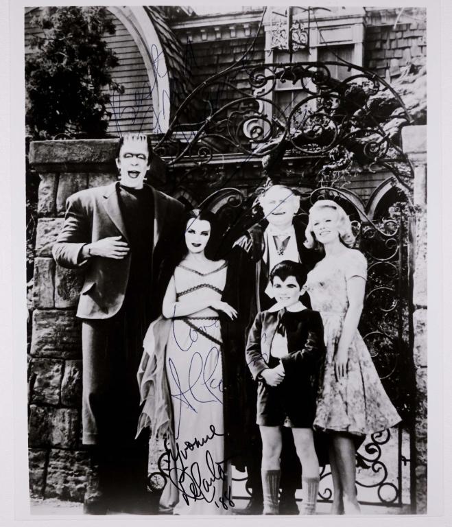 Autographs: 3 Munsters on a Cast Photo: Cast photo of the classic television series "The Munsters", signed by Fred Gwynne (Herman), Yvonne De Carlo (Lilli), and Al Lewis (Grandpa). *** PLEASE NOTE: Gwynne's autograph is hard to read because