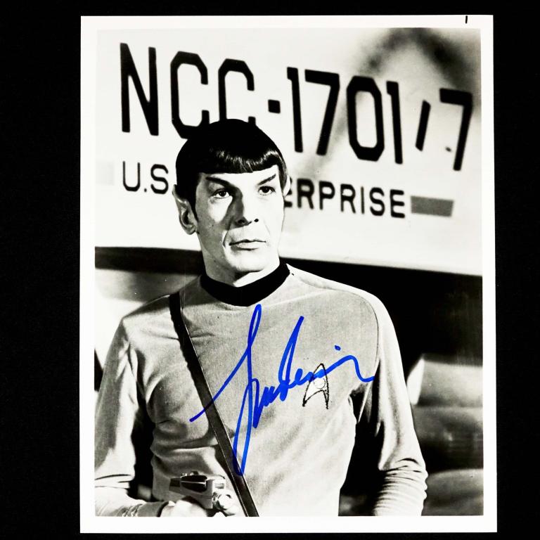 Autograph: Leonard Nimoy as Mr. Spock: Leonard Nimoy signed 8 x 10" black and white photo in his role as Mr. Spock from "Star Trek". Spock has his phaser drawn as he stands in front of the Galileo 7 shuttle. . ** Lot 14 makes the following