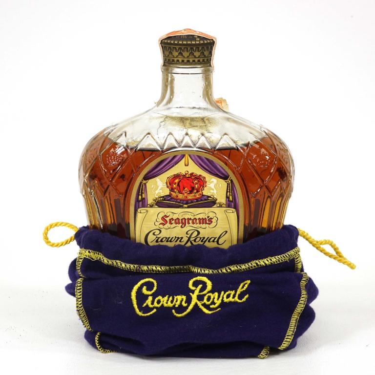 Bottle: 1955 Crown Royal 25 fl. oz. With Bag.: *** If shipping is needed, please call Ian at Lot 14 BEFORE bidding *** 1955 Crown Royal. 25 fl oz., with bag. If you may need shipping on bottles, you MUST talk to Ian before bidding.