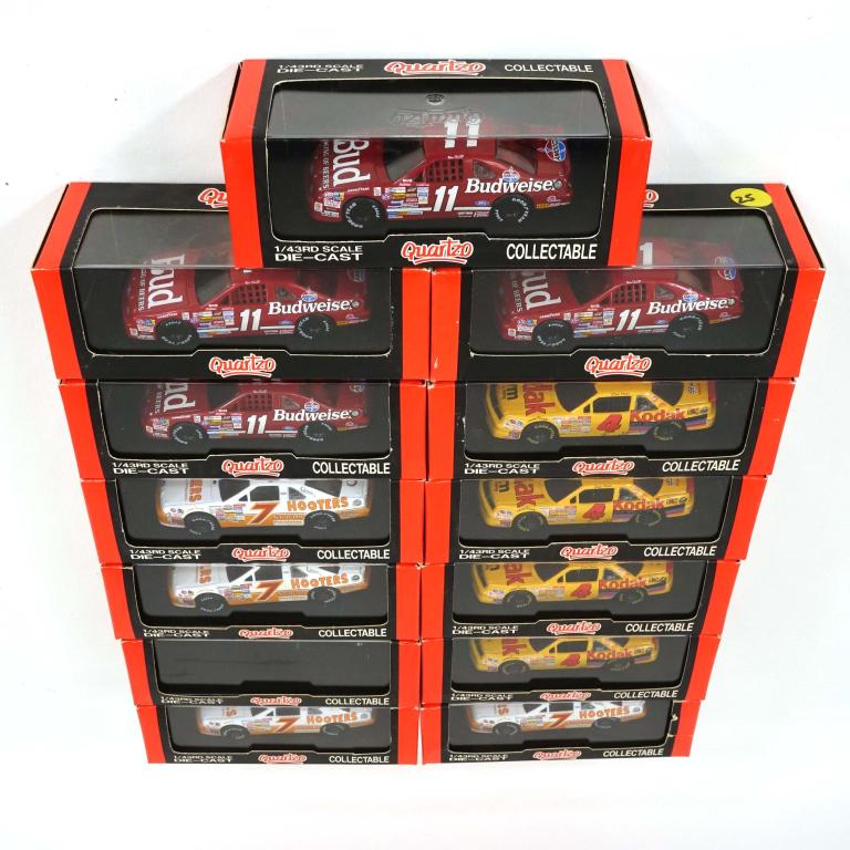 13 Quartzo Collectible Die-Cast Cars, 1/43 Scale: 4 Ford Thunderbird BUDWEISER, Bill Elliott, Manufacture year unknown.; 5 Ford Thunderbird HOOTERS, Alan Kulwicki, Manufacture year unknown.; 4 Chevy Lumina KODAK, Ernie Irvan, Manufacture year unknown