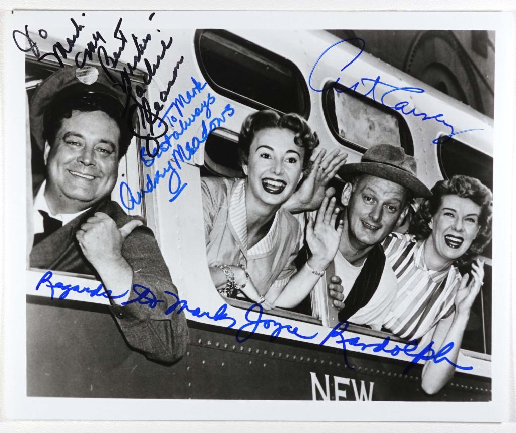 Autographs: "The Honeymooners" Cast Photo: Despite only running 39 episodes, this cast of four packed tremendous comedy into the short series. This is a 9-13/16 x 7-15/16" black & white photo of Ralph driving the bus, with Alice, Ed, and Trixi