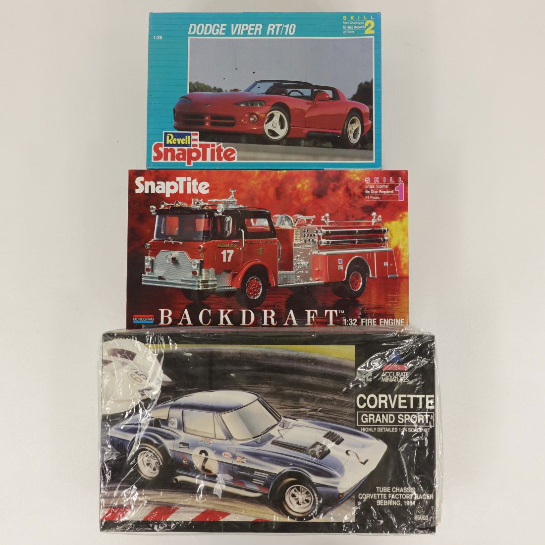Assortment Of 3 Vintage Model Vehicle Kits: 1 Revell Snaptite Dodge Viper RT/10, 1992. 1:25 scale. Made in U.S.A; 1 Monogram Snaptite Backdraft Fire Engine, 1991. 1:32 scale. Made in U.S.A; 1 Accurate Miniatures Corvette Grand Sport, 1995. 1:24