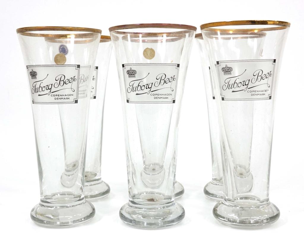 Set of Tuborg Beer Glasses: (6) Pilsner glasses. New old stock. Most glasses arrived wrapped in original box. Made in Belgium. Vintage.