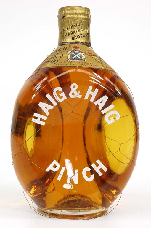 Bottle - Haig & Haig Pinch Whisky: Sealed bottle. Wire cage has a couple of breaks and small amount of sediment in bottle. Good fill. If you anticipate needing bottles shipped you MUST talk to Ian PRIOR to BIDDING! 847-625-0555.