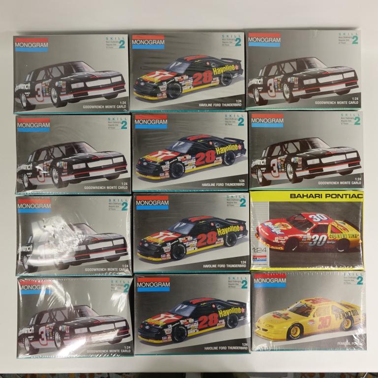12 Assorted Monogram Model Car Kits: Including: Bahari Pontiac, Goodwrench Monte Carlo, Pennzoil Pontiac, Havoline Ford Thunderbird. All 1:24 scale. All in shrinkwrap. Some boxes a bit caved from the shrinkwrap.
