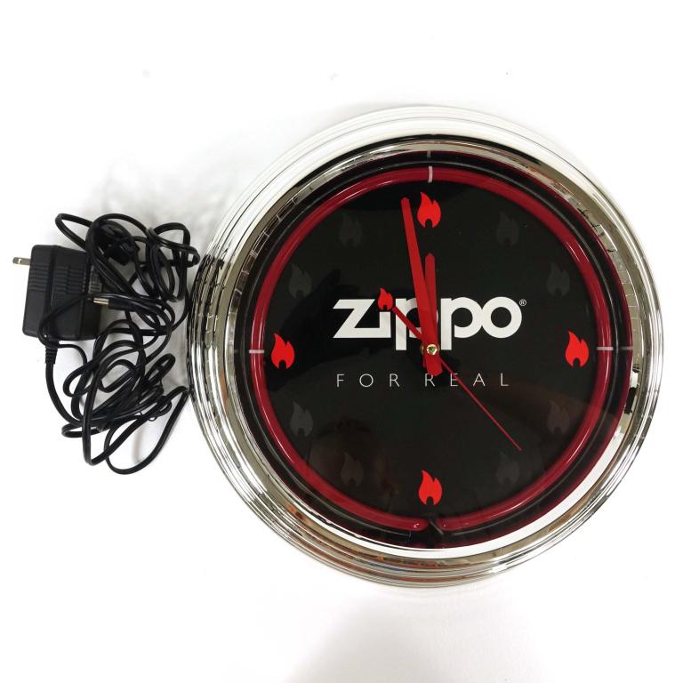 Red Zippo Neon Clock: Consignor reports new in box. Untested by Lot 14. Appears complete. 12.25" diameter.