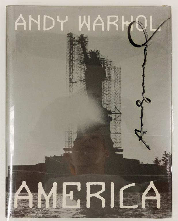 "America" by Andy Warhol - 1st Edition, DOUBLE SIGNED: DOUBLE SIGNED! One autograph on front dust jacket AND ANOTHER on page opposite the table of contents page. Card "cordially inviting" people to meet Andy autographing copes of his new book at The Museu