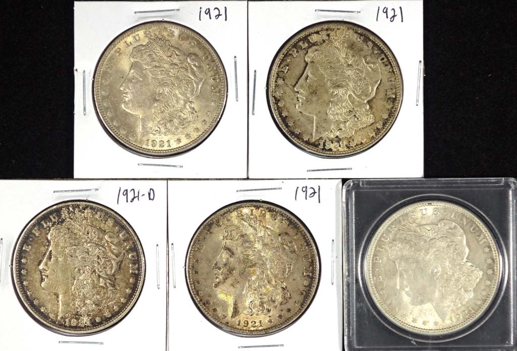 Five (5) Morgan Silver Dollars: Four 1921 Morgan silver dollars (Philadelphia Mint). (1) 1921 d Morgan Silver dollar (Denver Mint)