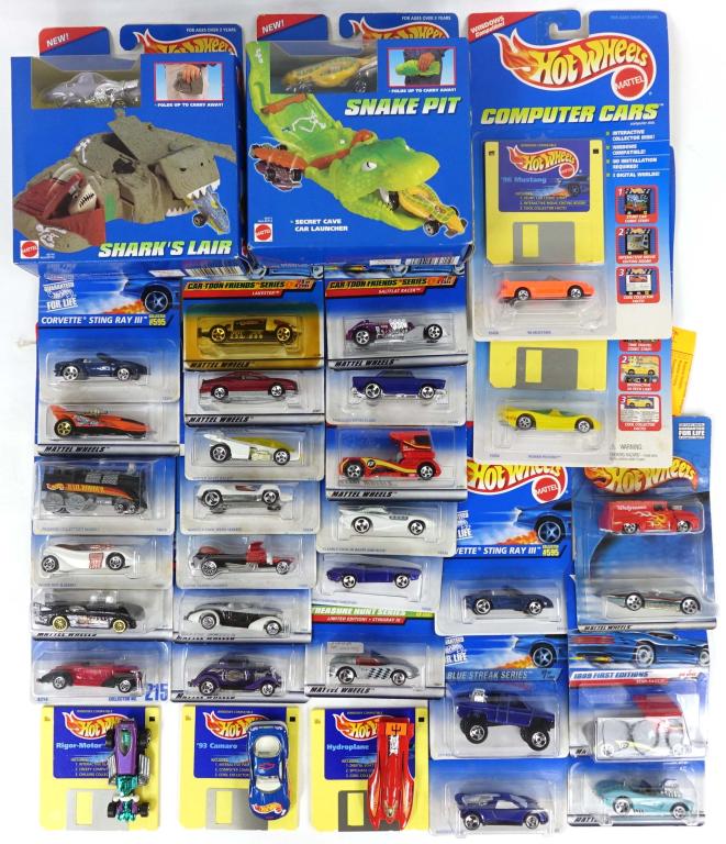 Assortment of Hot Wheels Vehicles: Assortment of die-cast Hot Wheels vehicles. Includes vehicles from various different collections such as Cartoon Friends Series, 1999 First Editions, Computer Cars, and Sto & Go. All models in excelle