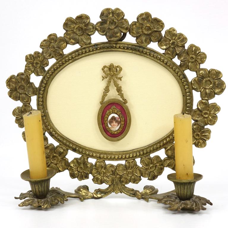 Brass Candle Wall Sconce: Brass candle wall sconce with framed cameo. Small chips to sides of frame, not visible from the front. 12" x 10.5" x 3.75".