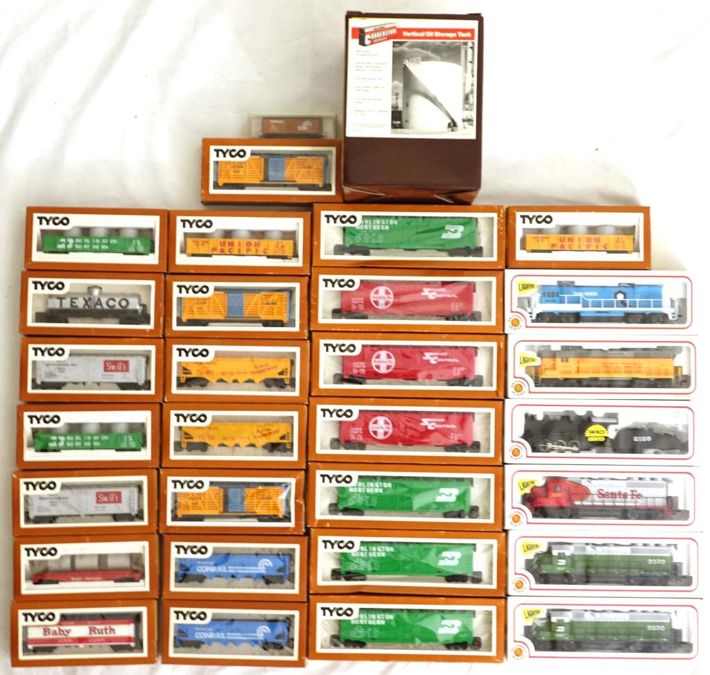 HO Trains - Bachmann, Tyco, Etc.: 1 The Rock Bachmann. 1 Santa Fe Bachmann. 1 Union Pacific. 2 Burlington Northern. 1 Black SF with assortment of Tyco trains and vertical oil storage tank.
