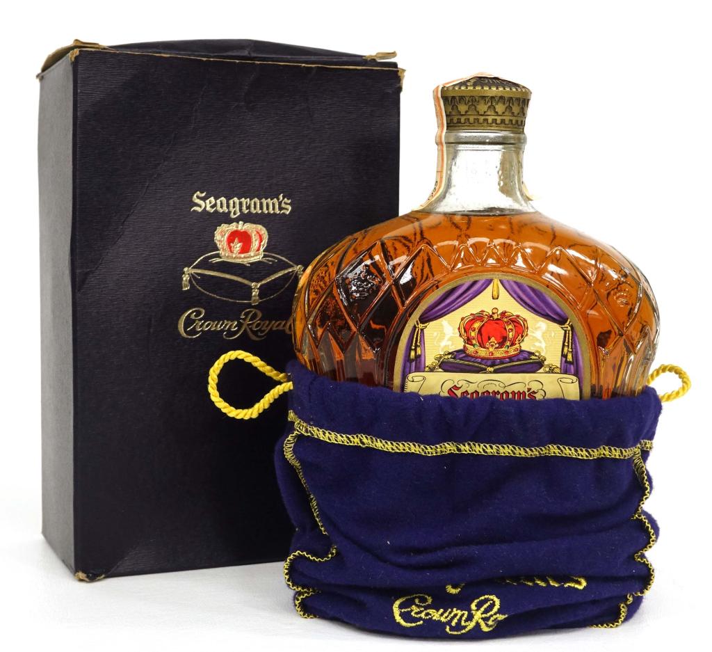 1955 Crown Royal Canadian Whisky Bottle: IF YOU MAY NEED SHIPPING YOU MUST SPEAK WITH IAN BEFORE BIDDING ON BOTTLES. Canada tax strip. 80 proof, 25 fluid oz., full, sealed, with clean box/bag.