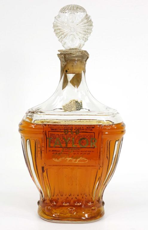 1953 Old Taylor Bourbon Whiskey Decanter: IF YOU MAY NEED SHIPPING YOU MUST SPEAK WITH IAN BEFORE BIDDING ON BOTTLES. 100 proof, 4/5 quart. Bottled in Bond. Sealed with tax strip (damage). Shoulder fill.