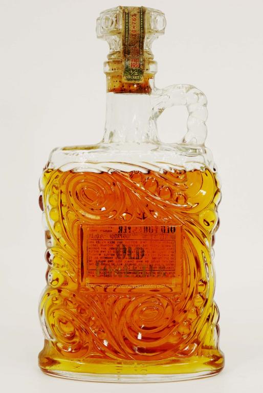 1953 Old Forester Bourbon Whiskey Bottle: IF YOU MAY NEED SHIPPING YOU MUST SPEAK WITH IAN BEFORE BIDDING ON BOTTLES. 100 proof. Bottled in Bond. Brown-Forman distillers. 4/5 quart. Sealed, with damage tax strip. Illinois tax stamp.