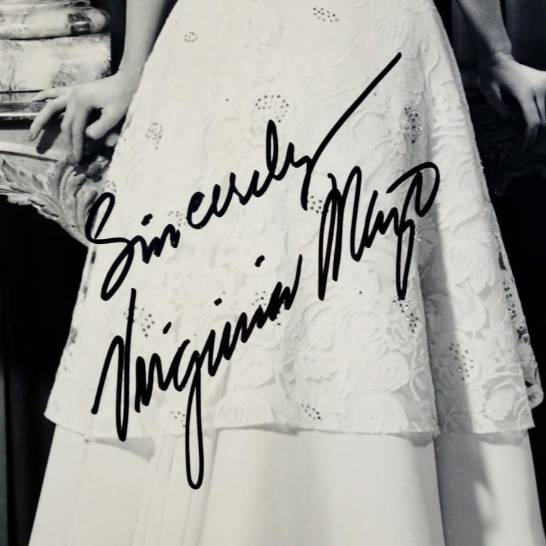 Virginia Mayo Autograph: Virginia Mayo signed 8 x 10" black and white publicity picture for the film "South Sea Woman". ** Lot 14 makes the following guarantee: If either Professional Sports Authenticator (PSA) or Beckett Glo