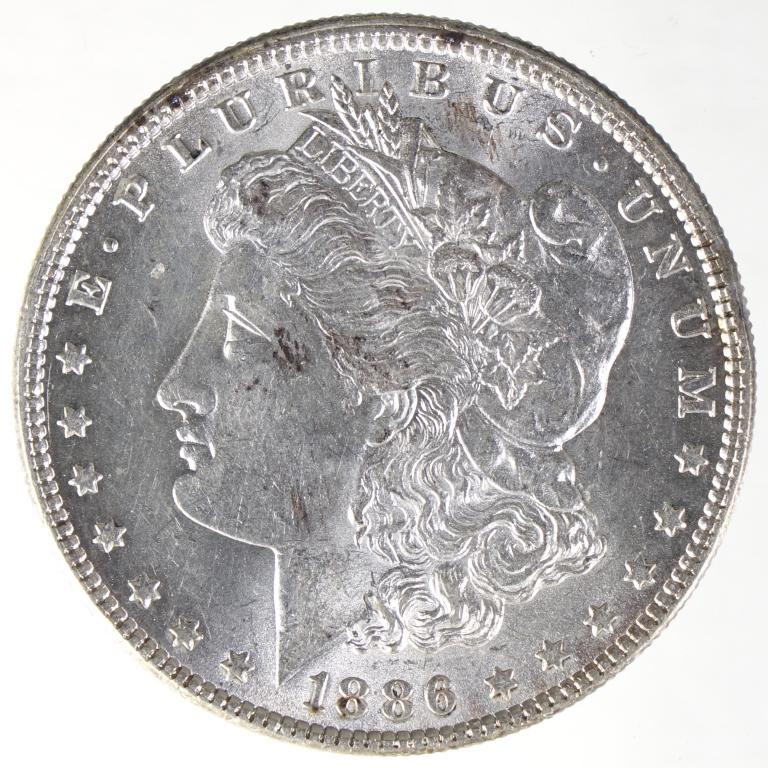 1886 Morgan Silver Dollar (BU?): 1886 Morgan silver dollar (Philadelphia Mint). 90% silver. Consigner reported as brilliant uncirculated. *** Please note: we are not professional coin graders. We are NOT grading these coins. We inclu
