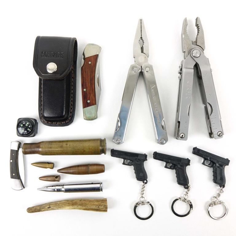 Knife / Multi-tool / Novelties Lot: Includes: Gerber + American Camper Multi-tools, Schrade Knife with sheath- 6.5 overall with a 2.75" blade, Browning penknife, and misc. Glock keychains + inert bullets / shell.
