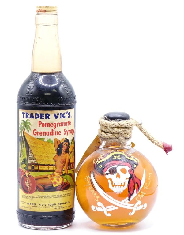 Trader Vics & Guavaberry Pirate Rum Bottles (2): *** IF YOU'RE NEW TO US AND MAY NEED SHIPPING PLEASE GIVE US A CALL BEFORE BIDDING ON BOTTLES! 847-625-0555 *** Trader Vic's Grenadine Syrup: 4/5 qt. Guavaberry Pirate Rum. No seal is present on the T
