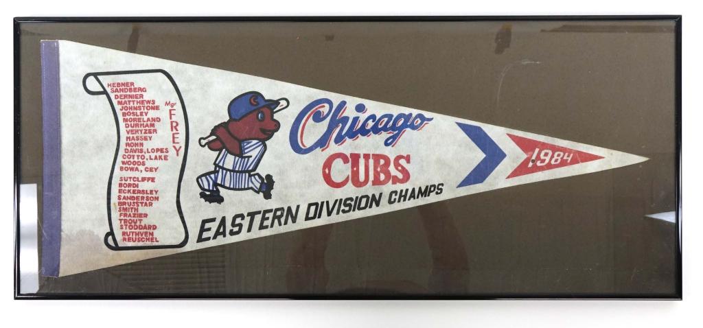 1984 Chicago Cubs Eastern Div. Champs Pennant: 29" x 11.5". Some staining and one hole. Creases visible. Currently in glass with frame. There is a small chip in glass carrier. Will ship, buyers preference.