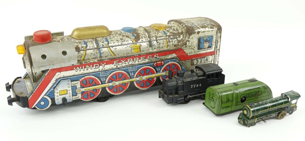 Tin Toy Train Engines (4): Windy Express #3214, 12" long. Loopline Shunter No. 4887, 4" long. Toy Engine No. 7744, 4" long. Toy Engine No. 393, 4" long, missing front left wheel.