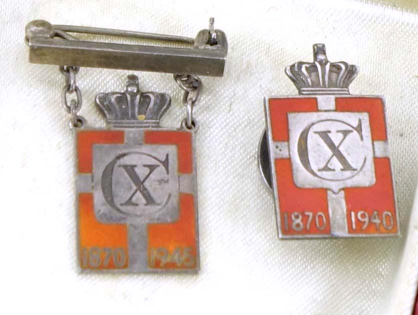 (2) Georg Jensen Silver & Enamel Patriotic Pins: A ladies' and man's WWII Danish silver and enameled patriotic badge by Georg Jensen, each with Christian X royal cypher and crown. The badge was designed by Arno Malinowski of Georg Jensen, issued twi