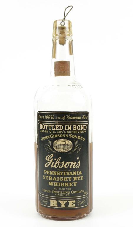 1947 Gibson's Pennsylvania Straight Rye Whisky: IF YOU MAY NEED SHIPPING YOU MUST SPEAK WITH IAN BEFORE BIDDING ON BOTTLES. Bottled in Bond. Cloudy - half full. Gibson Distillery, Aladdin, PA. 100 proof, 1 quart.