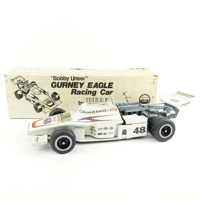 1975 (?) Beam Bobby Unser Racing Car Decanter: *** IF YOU MAY NEED SHIPPING YOU MUST SPEAK WITH IAN BEFORE BIDDING ON BOTTLES 847-625-0555 *** 1975 (?) Beam Bobby Unser Gurney Eagle Racing Car Decanter: 80 proof, 4/5 qt and sealed. New in box. Con